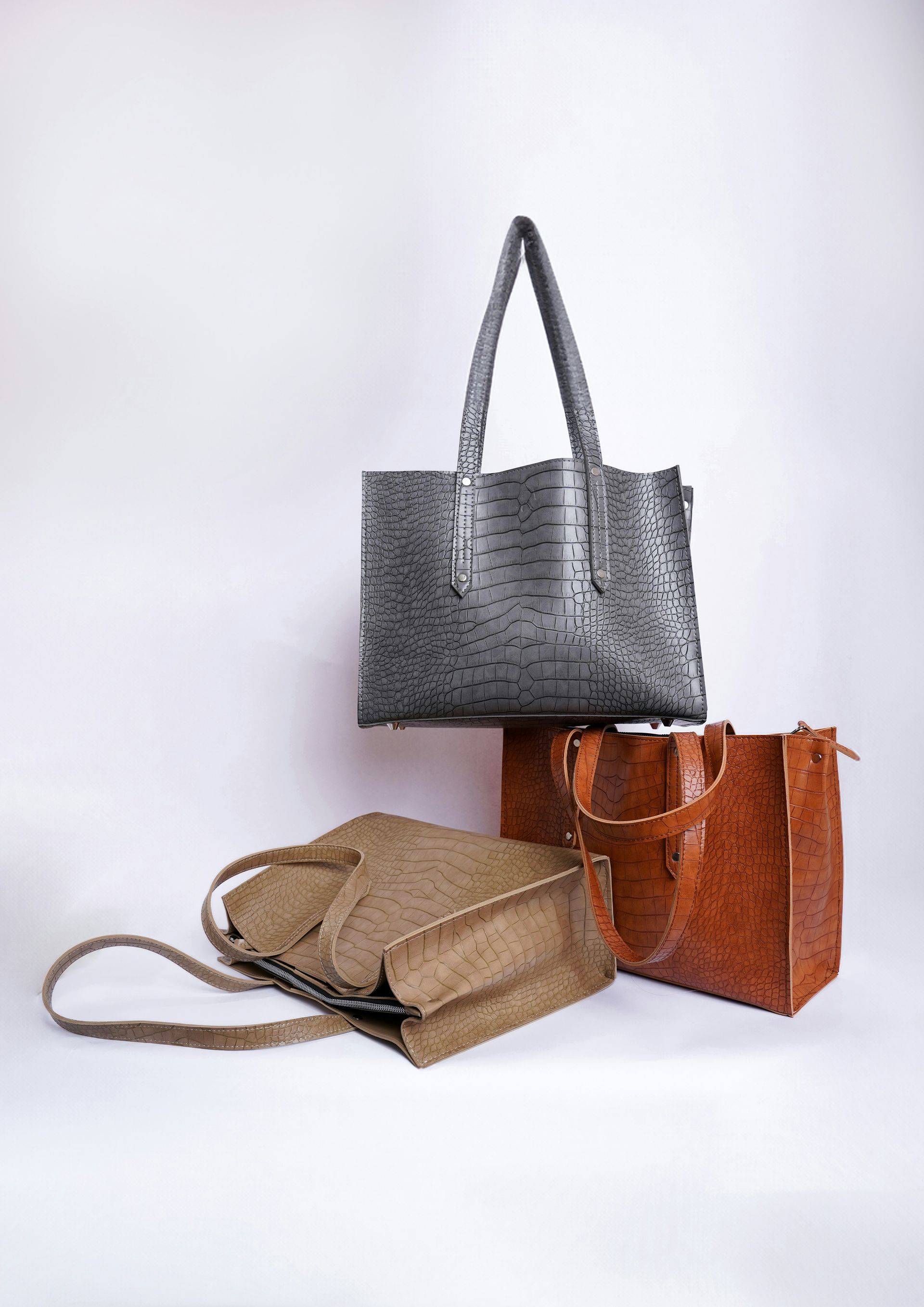 three different types of purses on a white background