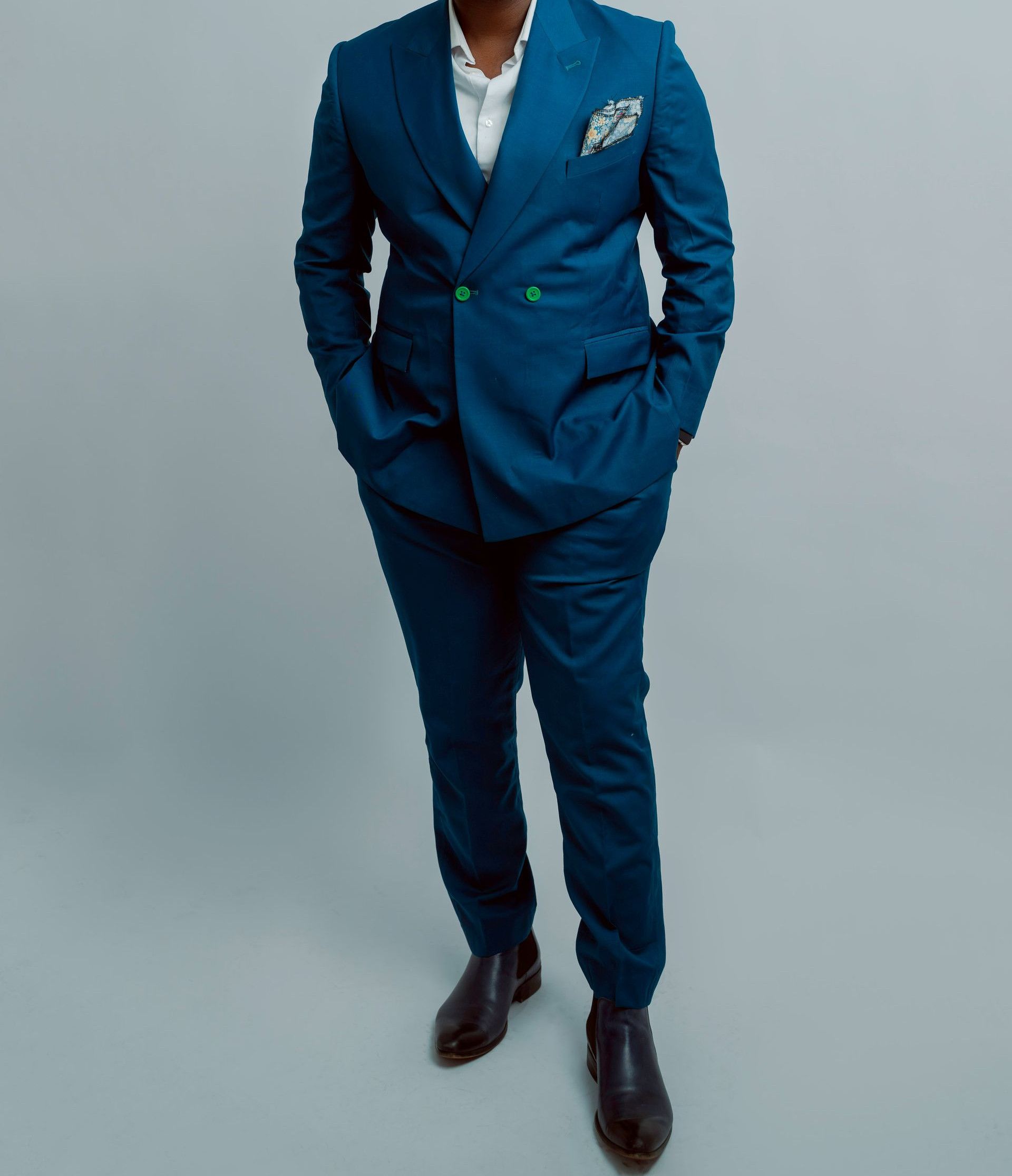 a man in a blue suit posing for a picture